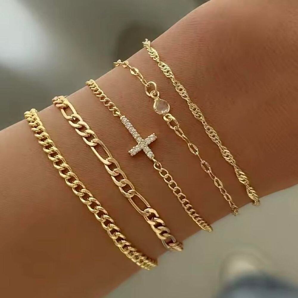 Gold layered bracelet stack with cross charm